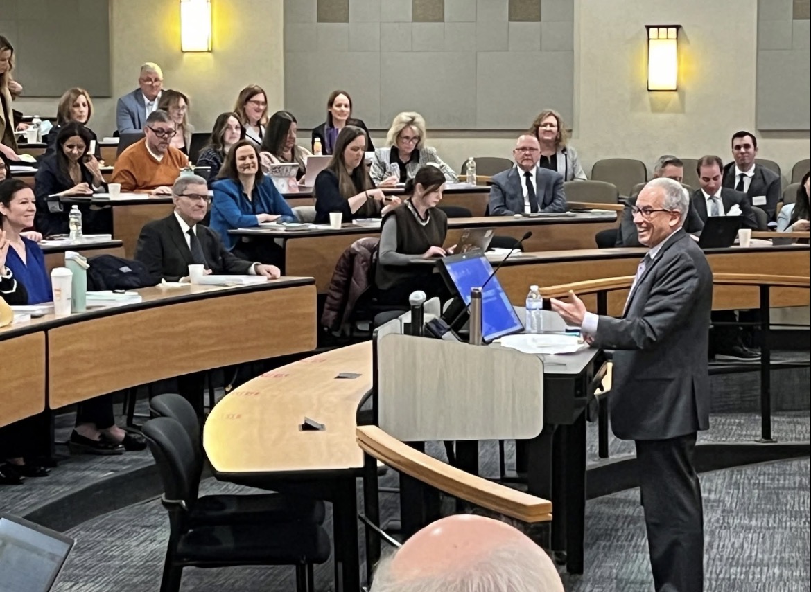 Eric Sachs teaching judges and attorneys in a lecture hall